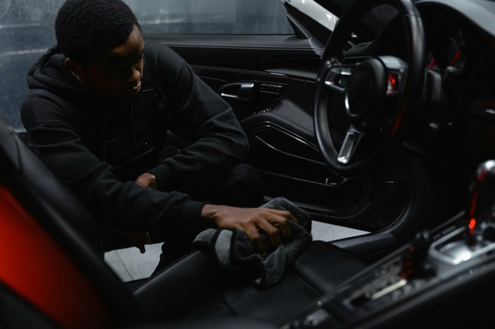 Detailer cleaning the interior of a car