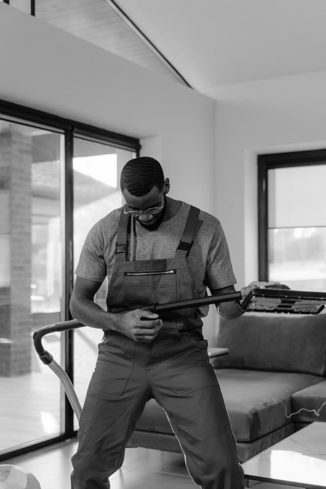 Technician steam cleaning a carpet with an extraction wand